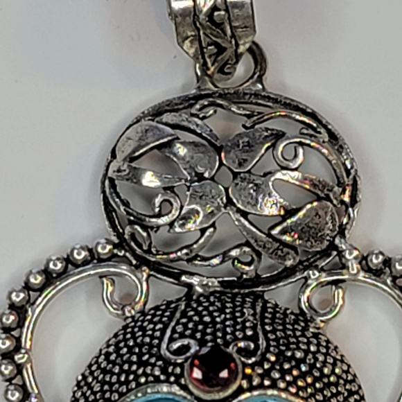 Sterling Silver Pendant with Blue Carved Face and Garnet Accents - Picture 9 of 12
